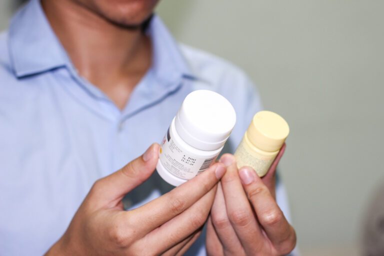 Finasteride Vs. Minoxidil: Which To Pick For Best Hair Growth 3 Man comparing two medicine bottles