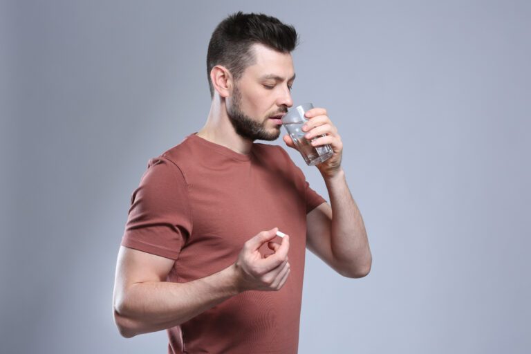 14 Best Hair Supplements for Thick, Luscious Hair  2 man taking a pill for hair growth